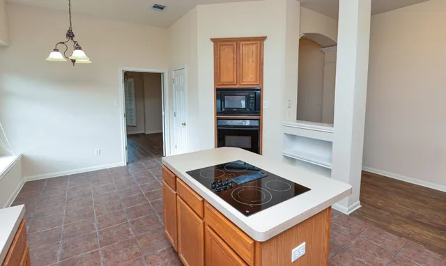 a kitchen that has a sink and a stove in it