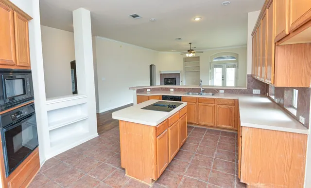 a kitchen that has a sink and a stove in it