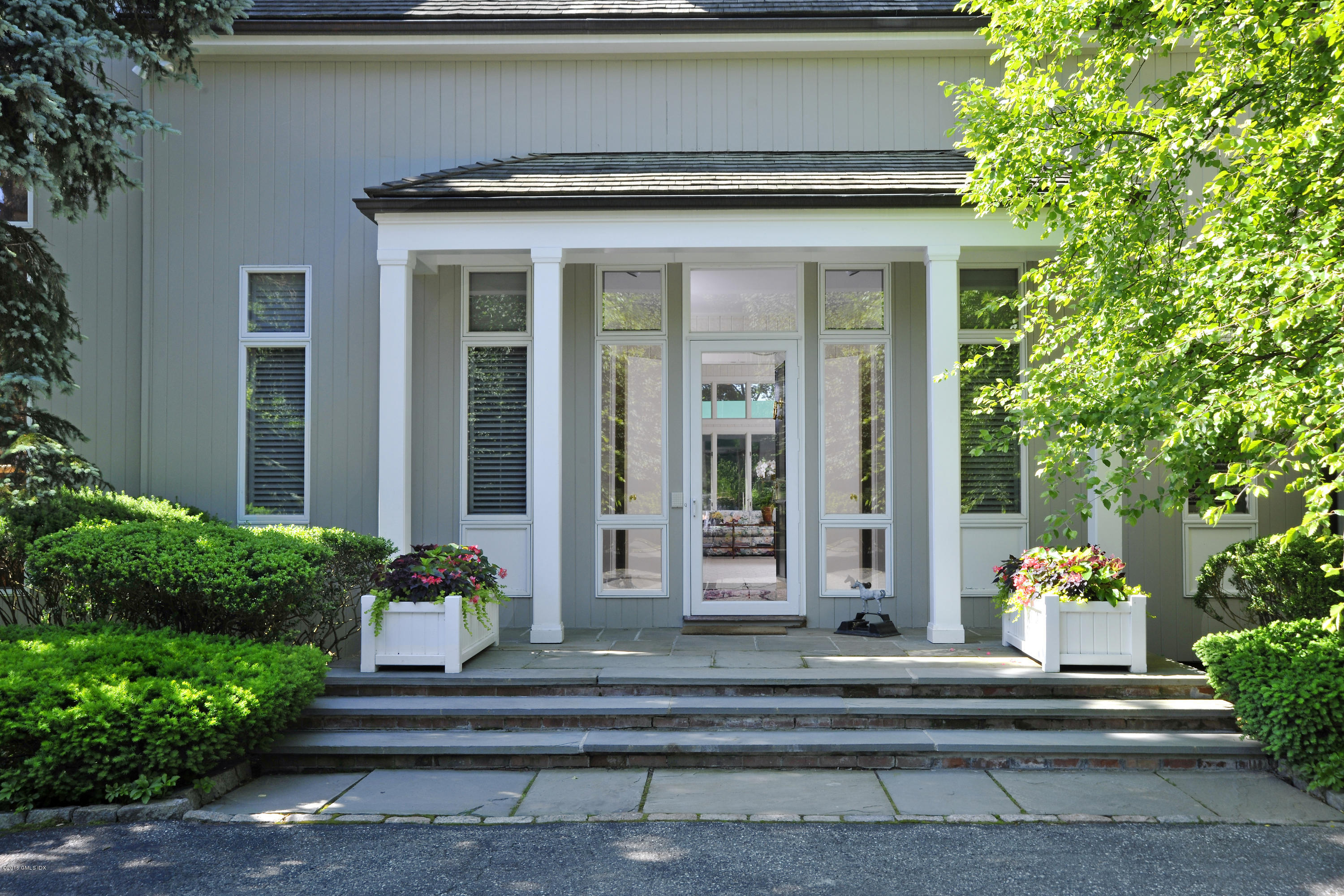 3 Old Mill Road Greenwich, CT 06830 - Photo 3 of 20 a front view of a house with a yard