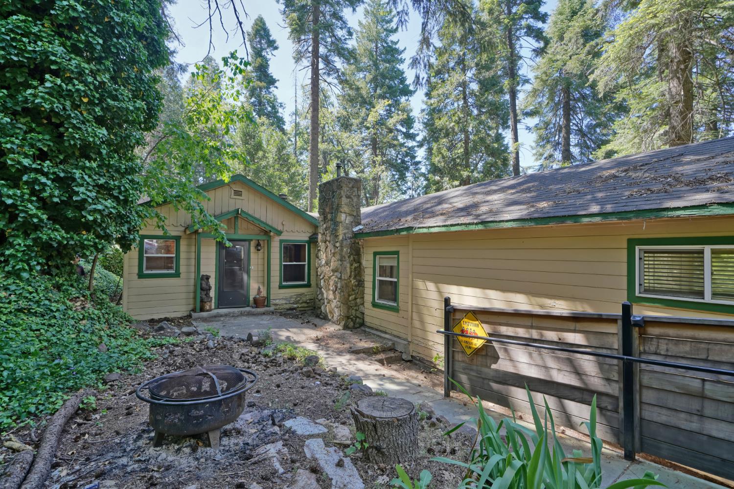 6929 Split Bend Road Pollock Pines, CA 95726 - Photo 5 of 38 a backyard of a house with barbeque oven fire pit table and chairs