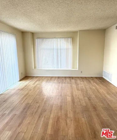a kitchen with granite countertop a stove cabinets and stainless steel appliances
