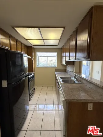 a kitchen with granite countertop stainless steel appliances stove and sink