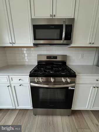 a kitchen with stainless steel appliances granite countertop a stove and a microwave