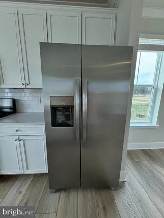 a kitchen with cabinets and a refrigerator