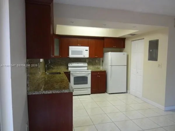 a white refrigerator freezer sitting in a kitchen
