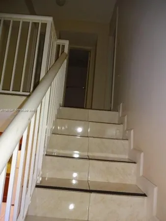 an empty room with a empty space and windows