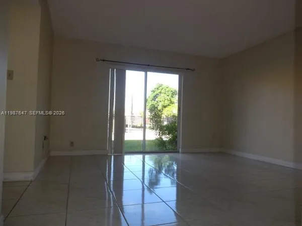 a view of an empty room and a window