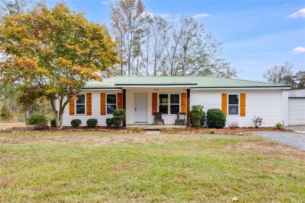 274 Holly Road Bowdon, GA 30108 - Photo 1 of 1 a front view of a house with a garden and yard