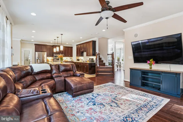 a living room with furniture wooden floor and a rug