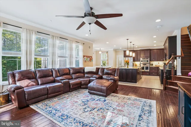 a kitchen with stainless steel appliances granite countertop a sink a stove and a wooden cabinets