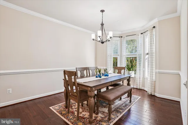a view of a hallway with wooden floor and dining room