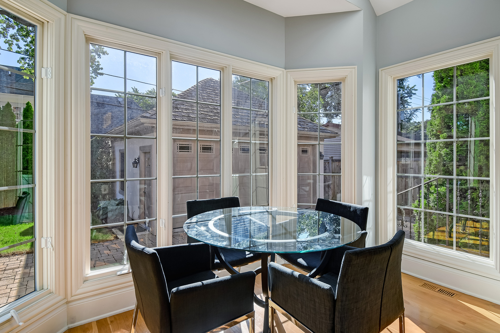 621 North County Line Road Hinsdale, IL 60521 - Photo 11 of 48 a view of a dining room with furniture large windows and wooden floor
