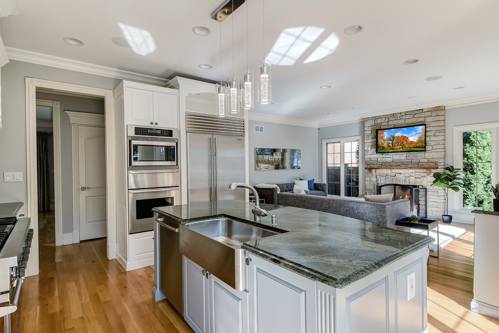 621 North County Line Road Hinsdale, IL 60521 - Photo 12 of 48 a kitchen with stainless steel appliances granite countertop a sink a stove and a wooden floors