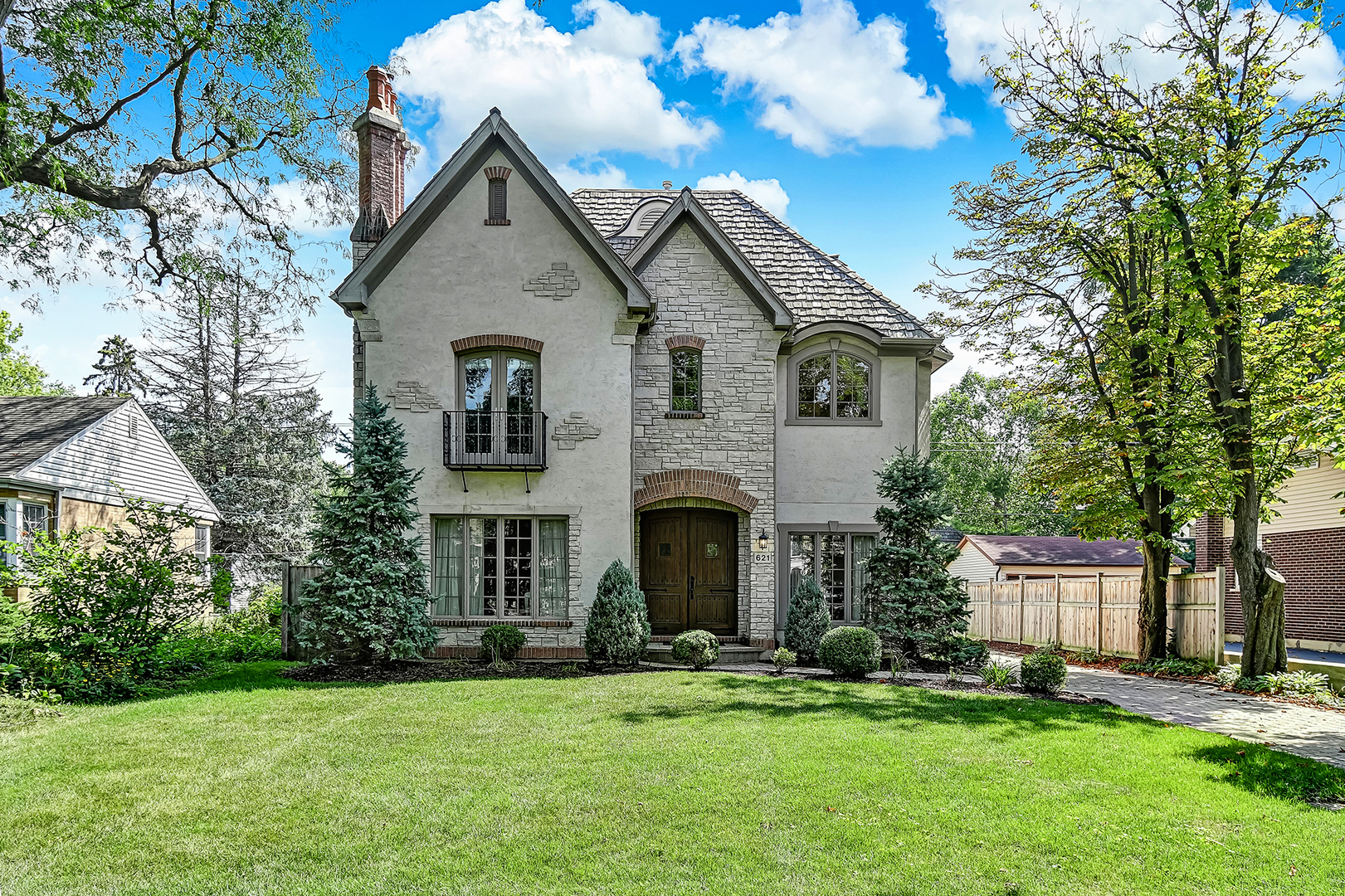 621 North County Line Road Hinsdale, IL 60521 - Photo 3 of 48 a front view of a house with a yard and trees