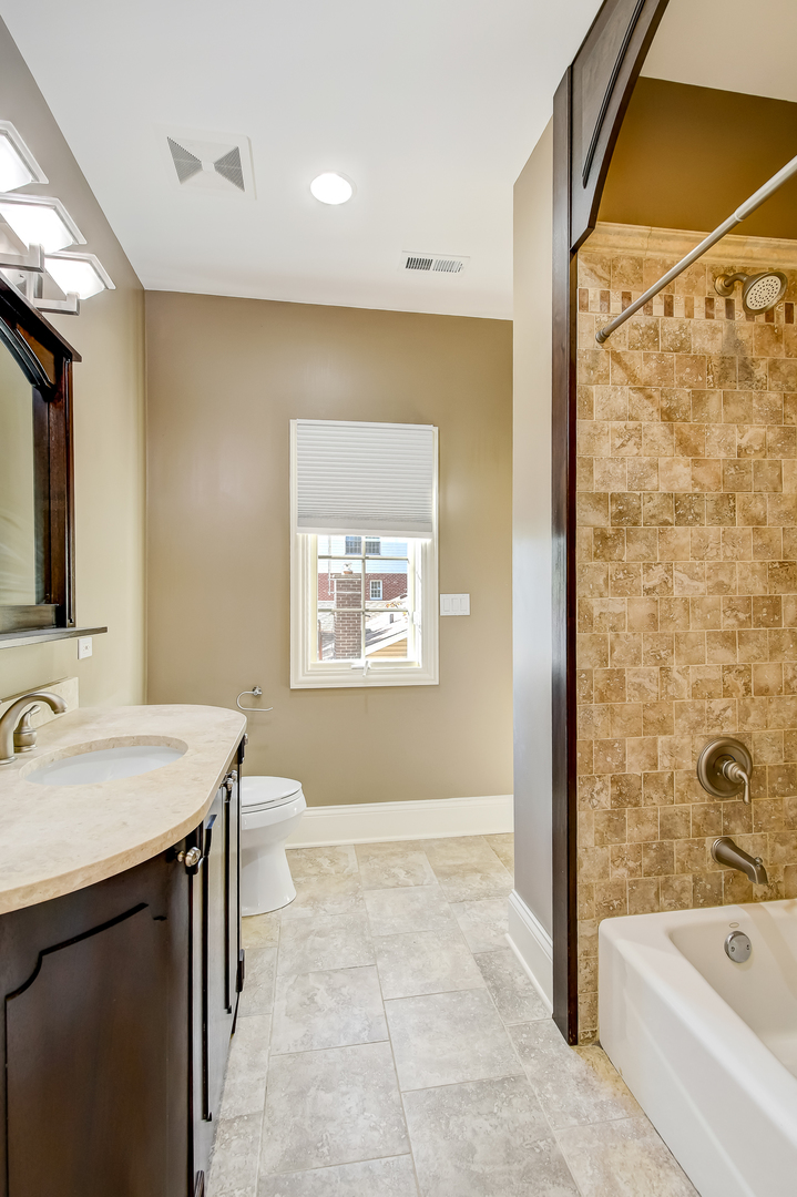 621 North County Line Road Hinsdale, IL 60521 - Photo 25 of 48 a bathroom with a sink a mirror and a bathtub