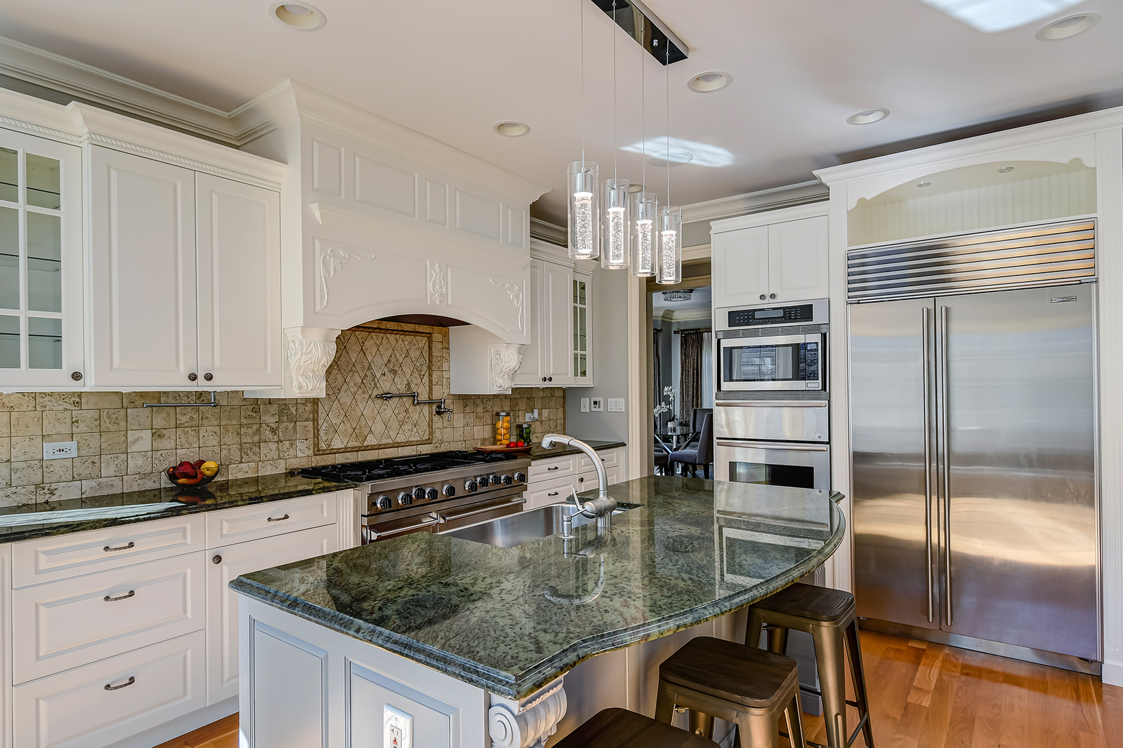 621 North County Line Road Hinsdale, IL 60521 - Photo 8 of 48 a kitchen with stainless steel appliances granite countertop a sink a stove and a refrigerator