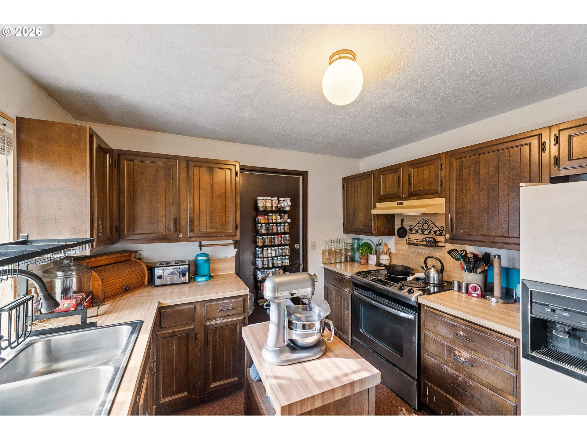 2031 Kincheloe Lane Myrtle Point, OR 97458 - Photo 11 of 33 a kitchen with a sink stove top oven and cabinets
