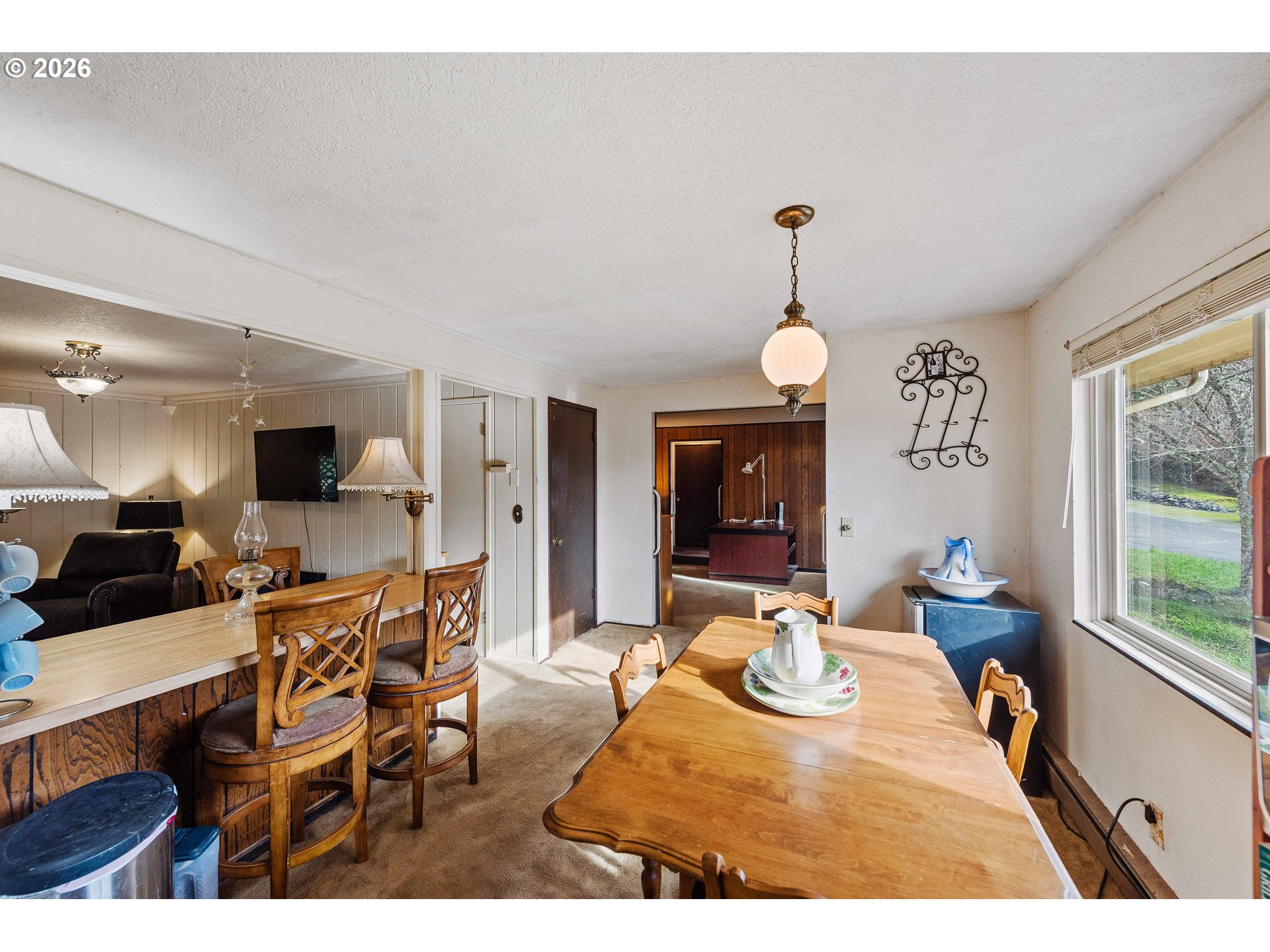 2031 Kincheloe Lane Myrtle Point, OR 97458 - Photo 13 of 33 a view of a dining room with furniture and a large window