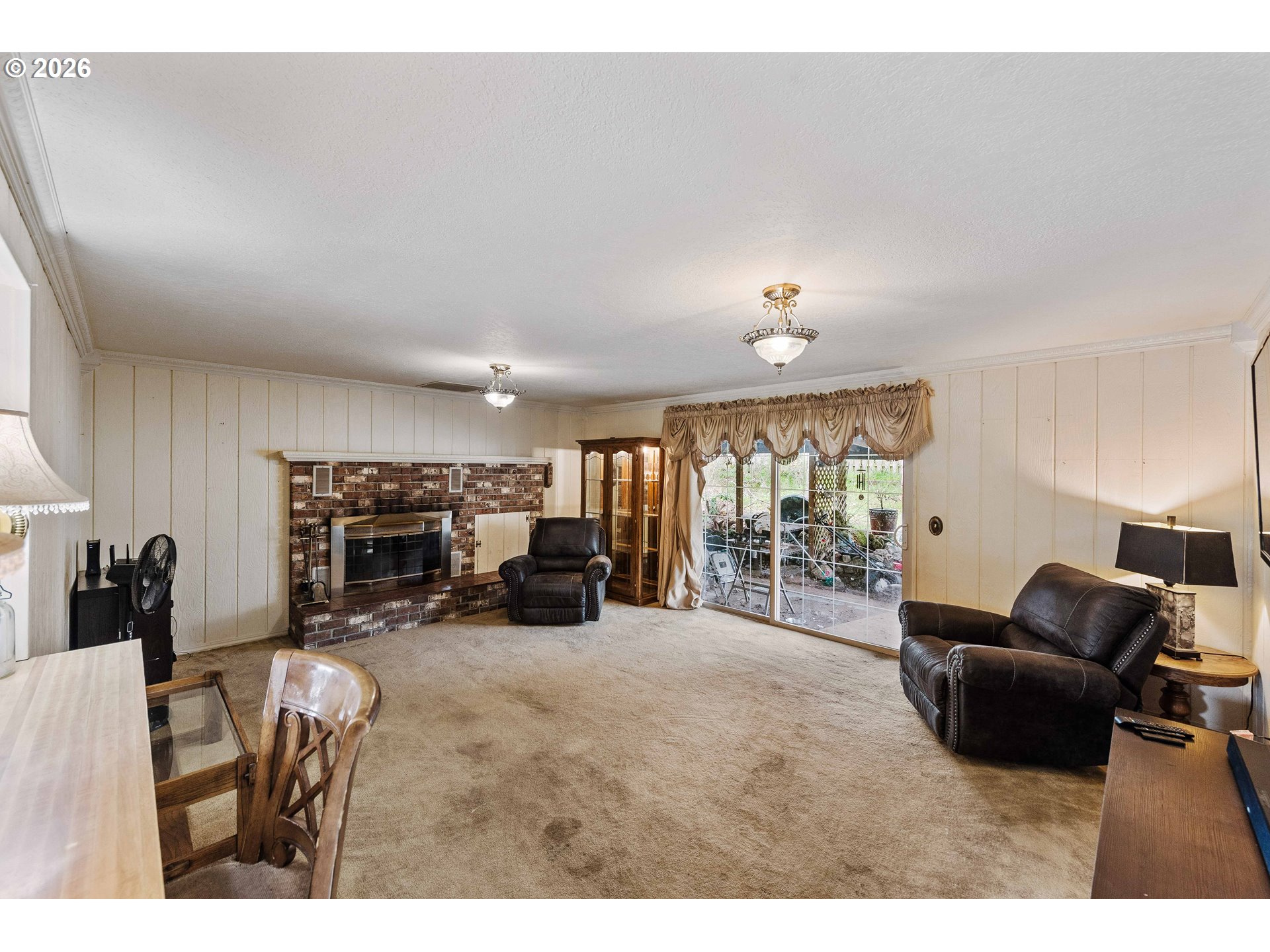 2031 Kincheloe Lane Myrtle Point, OR 97458 - Photo 14 of 33 a living room with furniture a fireplace and large windows