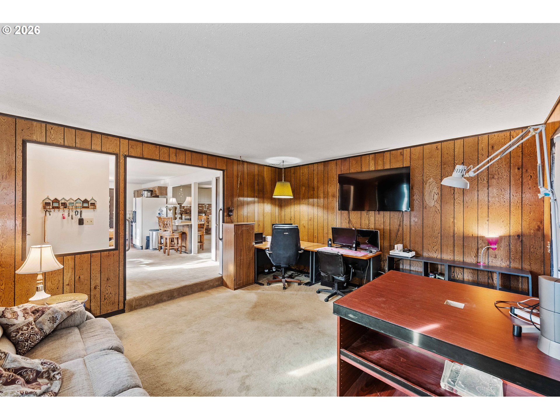 2031 Kincheloe Lane Myrtle Point, OR 97458 - Photo 18 of 33 a living room with furniture a flat screen tv and floor to ceiling window