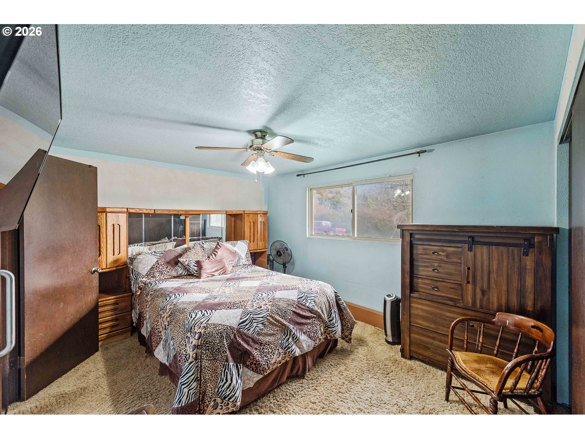 2031 Kincheloe Lane Myrtle Point, OR 97458 - Photo 19 of 33 a bedroom with a bed and a chandelier