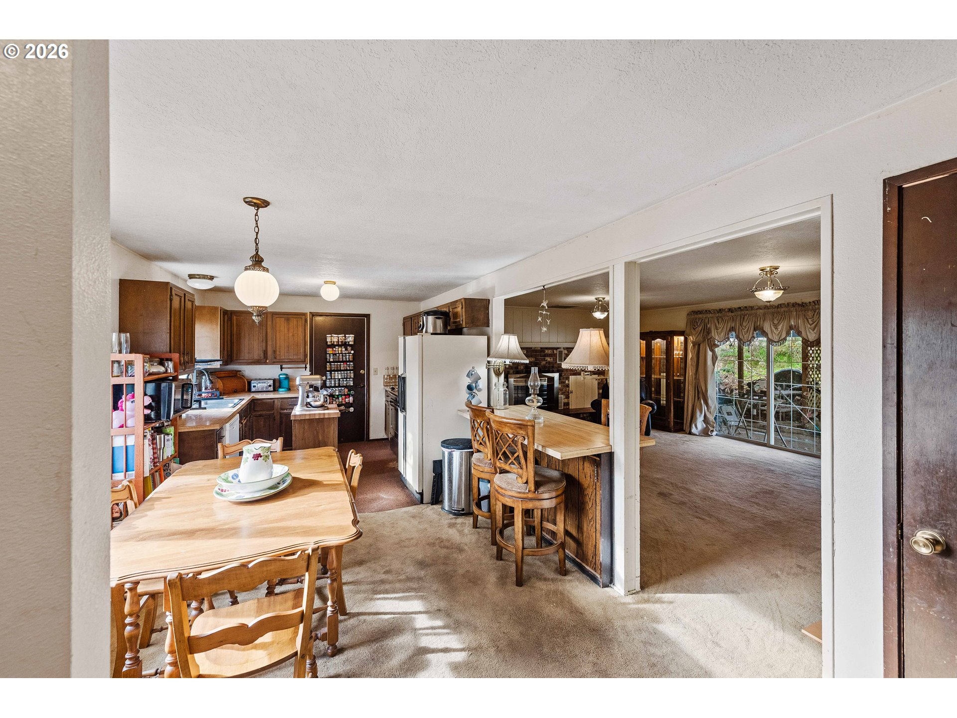 2031 Kincheloe Lane Myrtle Point, OR 97458 - Photo 9 of 33 a living room with furniture a chandelier and fireplace