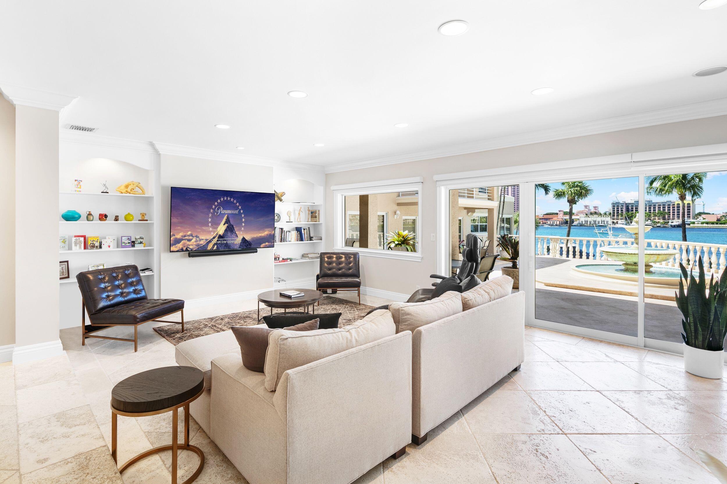 555 South Ocean Boulevard, Unit 4 Boca Raton, FL 33432 - Photo 13 of 39 a living room with furniture and a flat screen tv