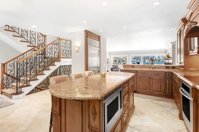 a kitchen with granite countertop a stove and a refrigerator