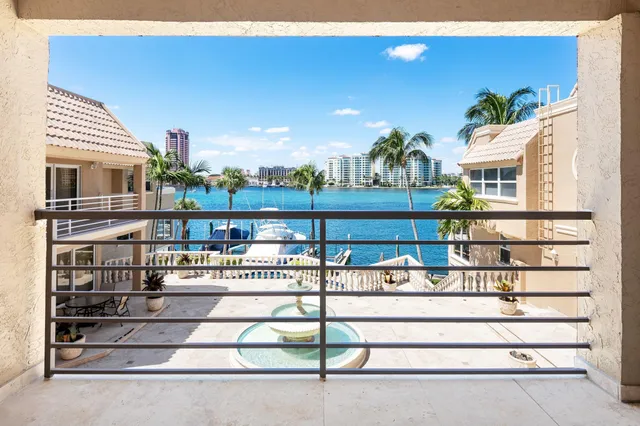 a large bedroom with a bed and wooden floor