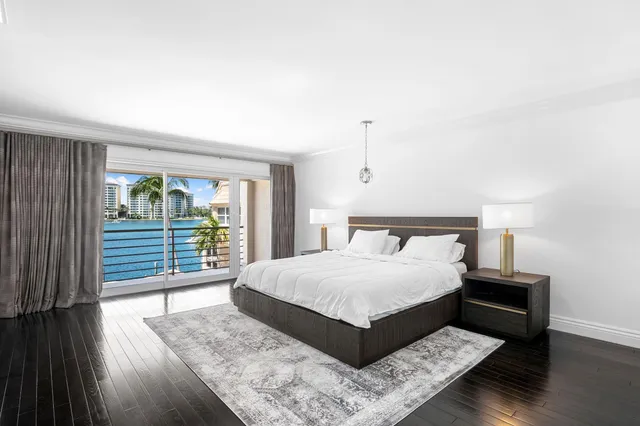 a bedroom with a large bed and a large window