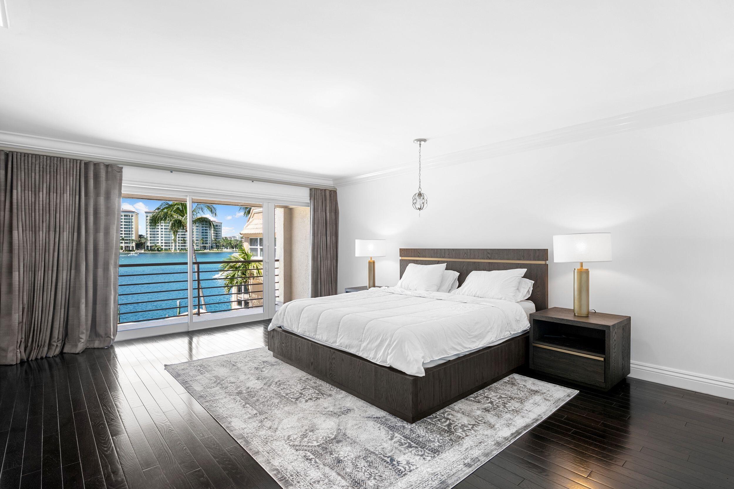 555 South Ocean Boulevard, Unit 4 Boca Raton, FL 33432 - Photo 24 of 39 a large bedroom with a bed and wooden floor