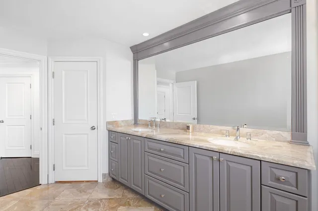 a bathroom with a granite countertop sink mirror and double
