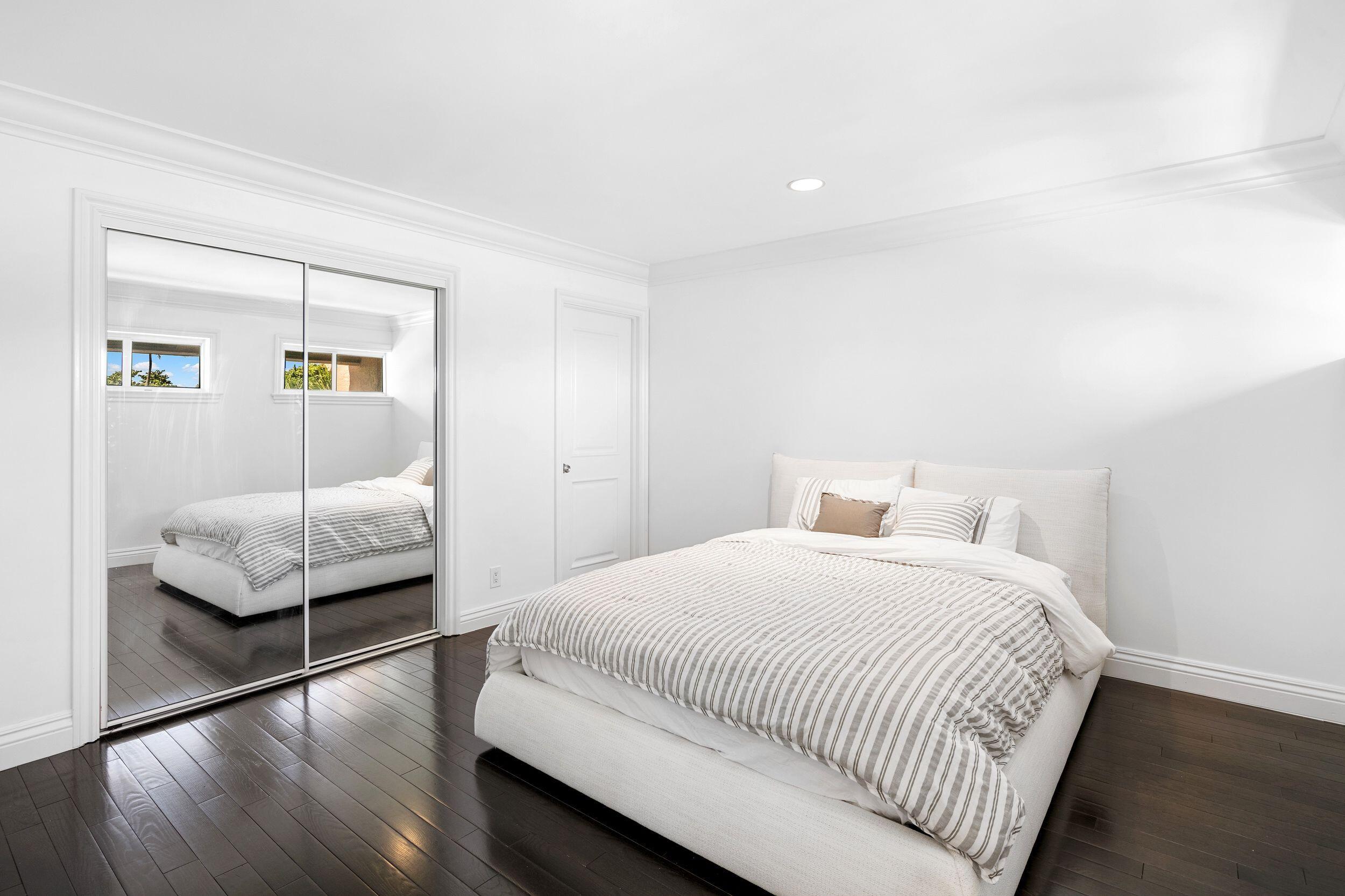 555 South Ocean Boulevard, Unit 4 Boca Raton, FL 33432 - Photo 29 of 39 a bedroom with a bed and a couch