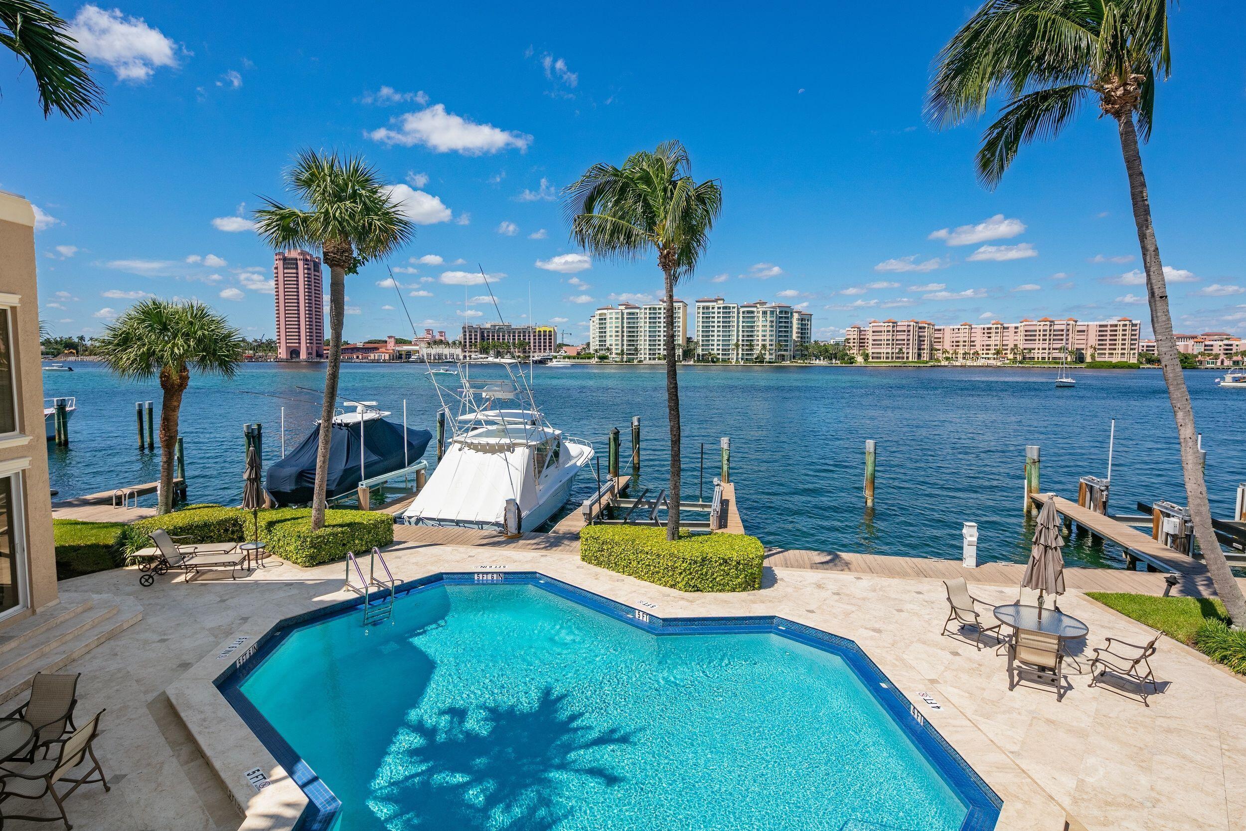 555 South Ocean Boulevard, Unit 4 Boca Raton, FL 33432 - Photo 8 of 39 a view of a swimming pool with a patio and a garden