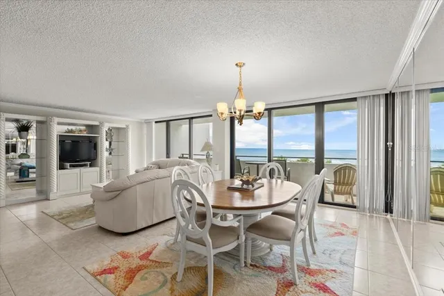 a dining room with furniture and a chandelier