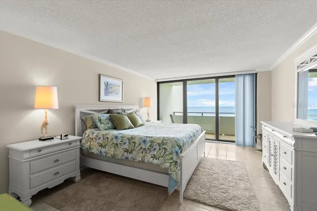 a bedroom with a bed and a dresser next to a window