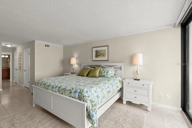 a bedroom with a bed and a night stand