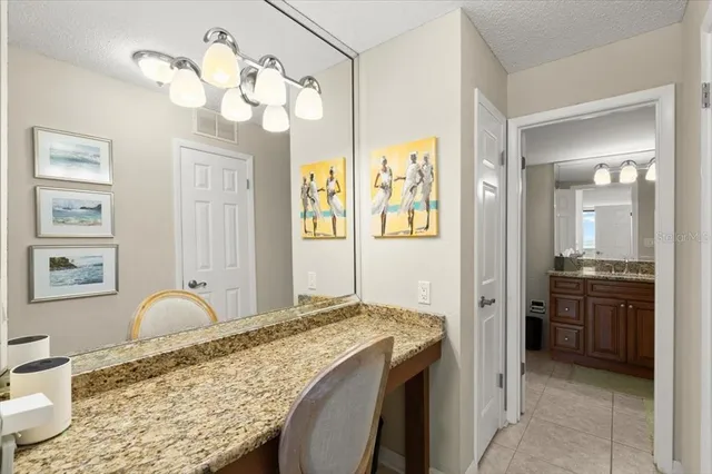 a spacious bathroom with a granite countertop sink a mirror and a shower