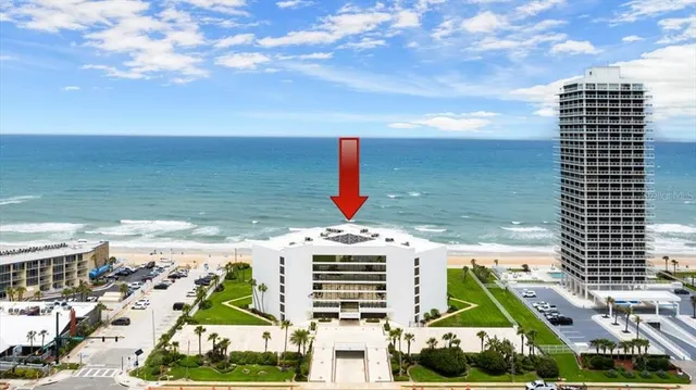 a view of a patio with dining table and chairs with a barbeque