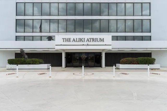 a roof deck with table and chairs and potted plants