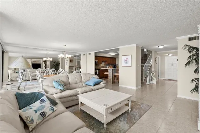 a living room with furniture and kitchen view