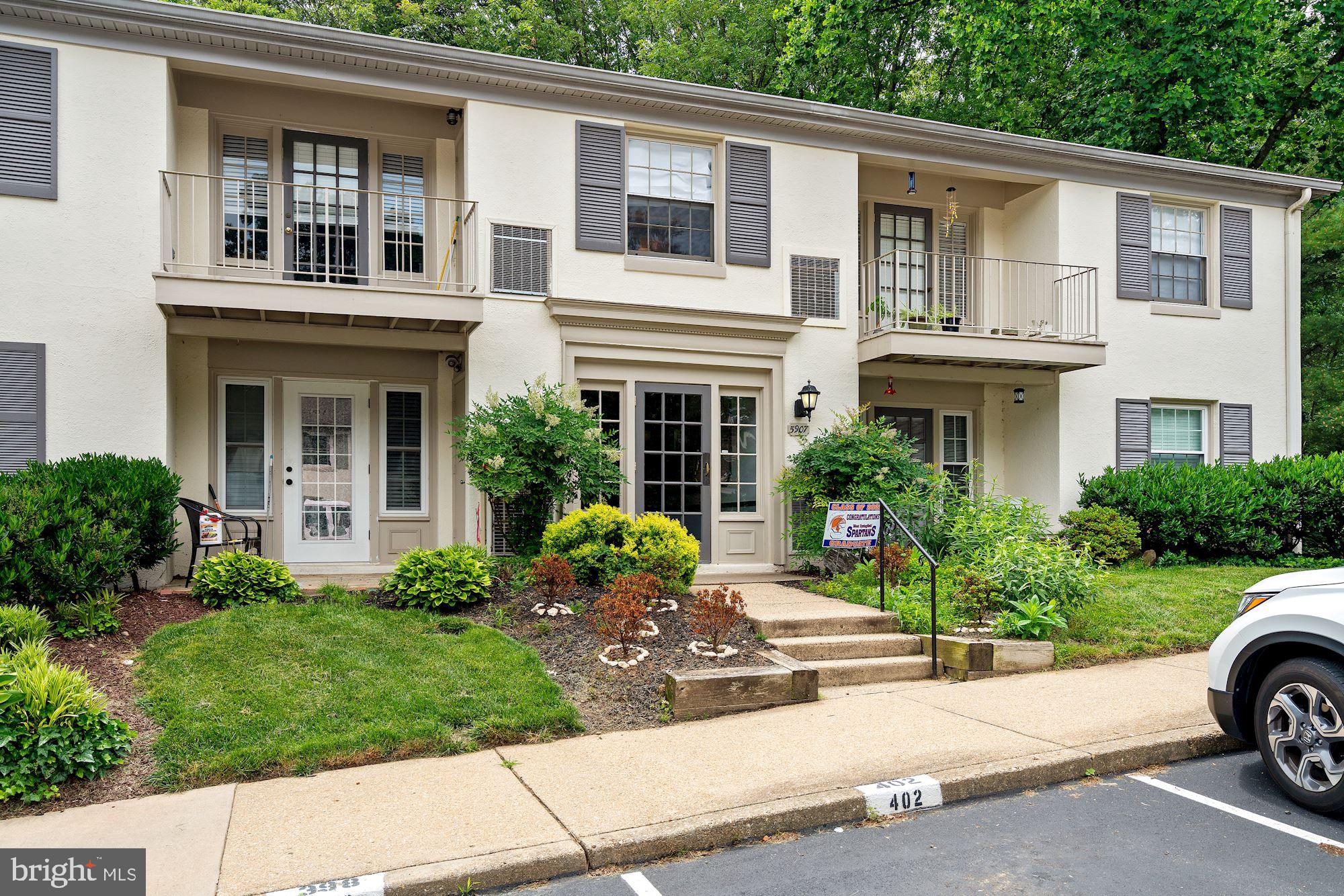 a front view of a house with a garden and plants