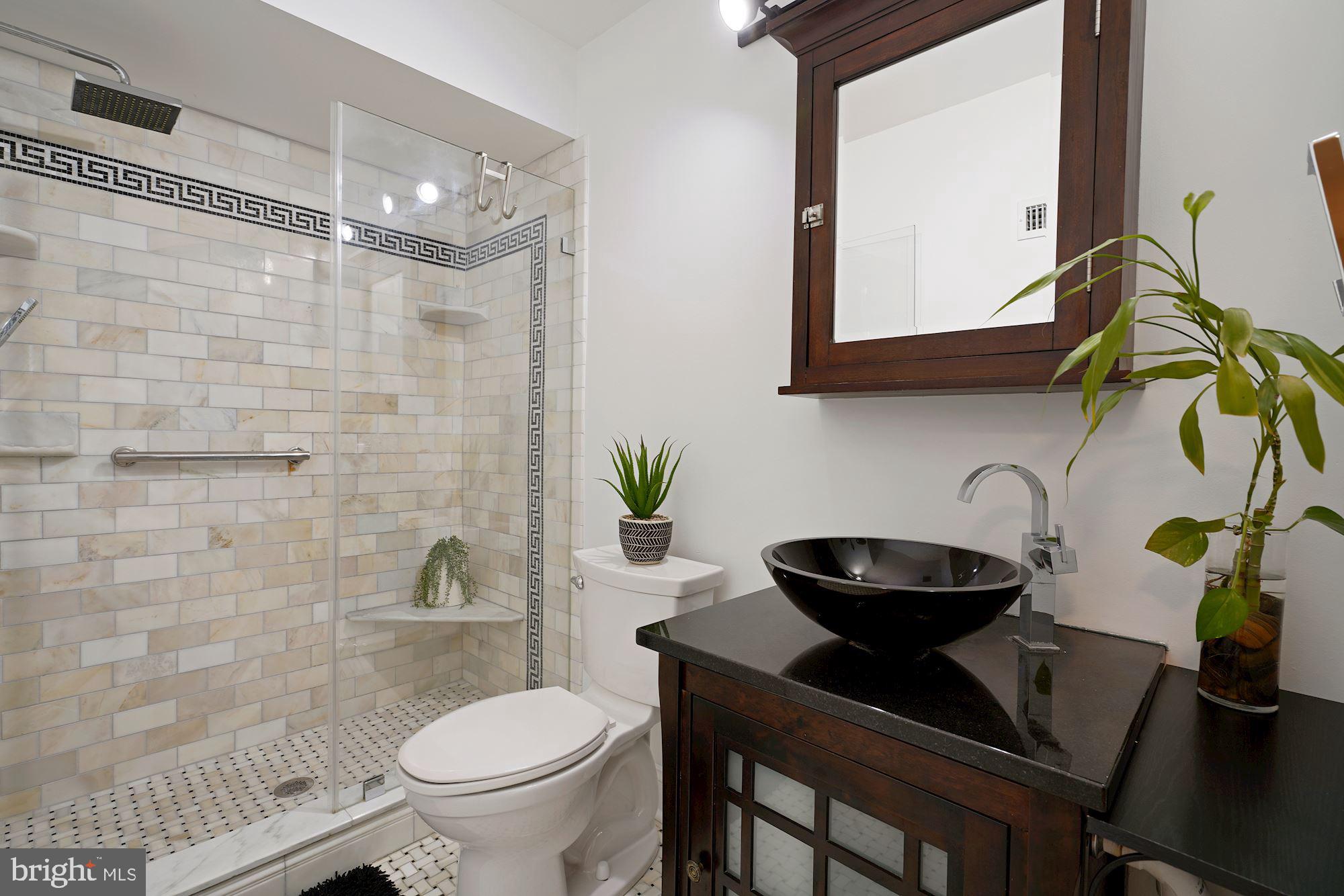 5907 G Kingsford Road, Unit 400 Springfield, VA 22152 - Photo 12 of 20 a bathroom with a toilet sink and mirror