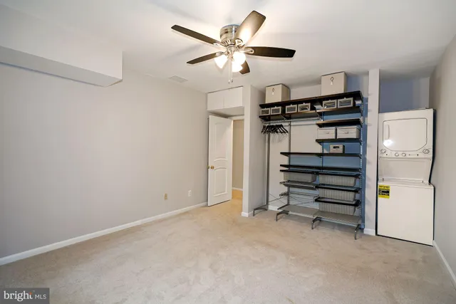 a view of an empty room with a ceiling fan