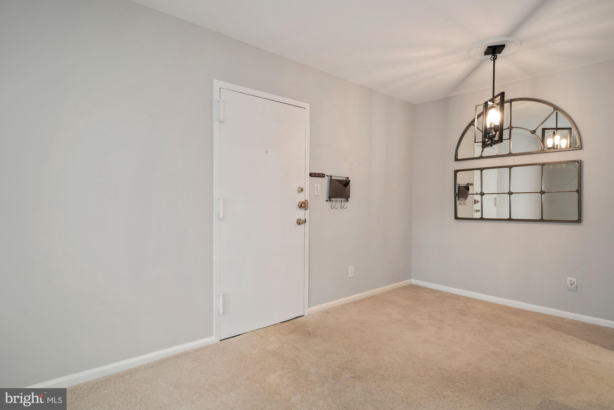5907 G Kingsford Road, Unit 400 Springfield, VA 22152 - Photo 4 of 20 a view of a livingroom with wooden floor and window
