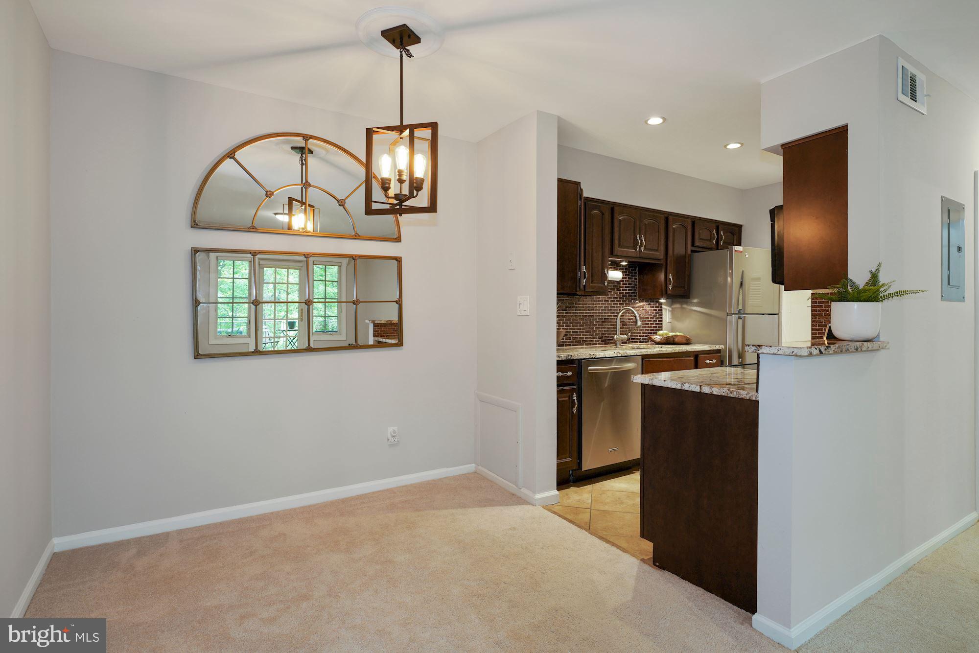 5907 G Kingsford Road, Unit 400 Springfield, VA 22152 - Photo 8 of 20 a kitchen with stainless steel appliances granite countertop a stove a sink and a refrigerator