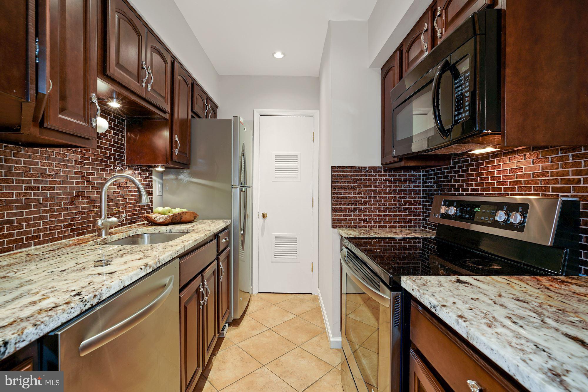 5907 G Kingsford Road, Unit 400 Springfield, VA 22152 - Photo 10 of 20 a kitchen that has a sink and a stove