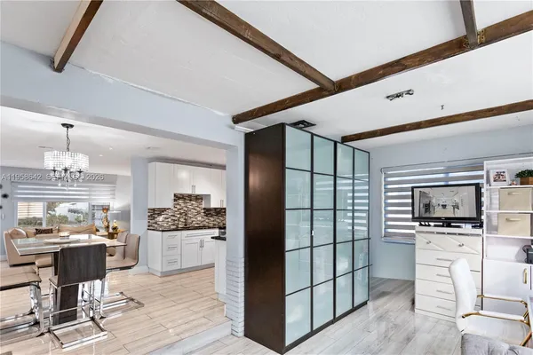 a kitchen with stainless steel appliances kitchen island granite countertop a refrigerator and cabinets