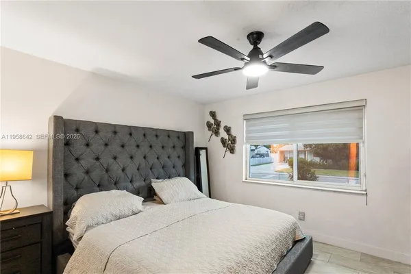 a bedroom with a bed and a window