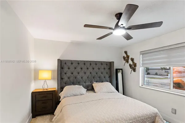 a bedroom with a bed and a window